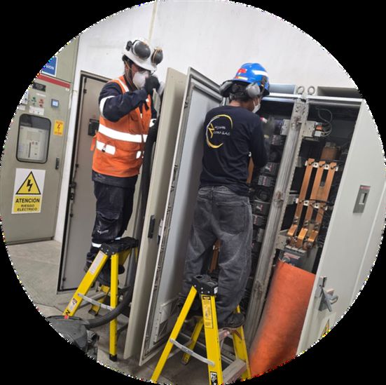 Technicians inspecting a switchboard